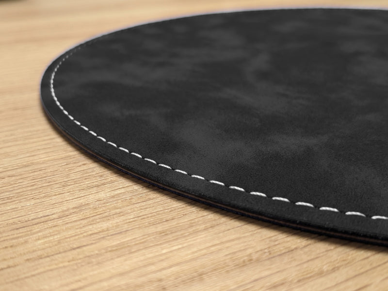 Close-up of the white stitched edge of the 1.3 mm round mouse pad
