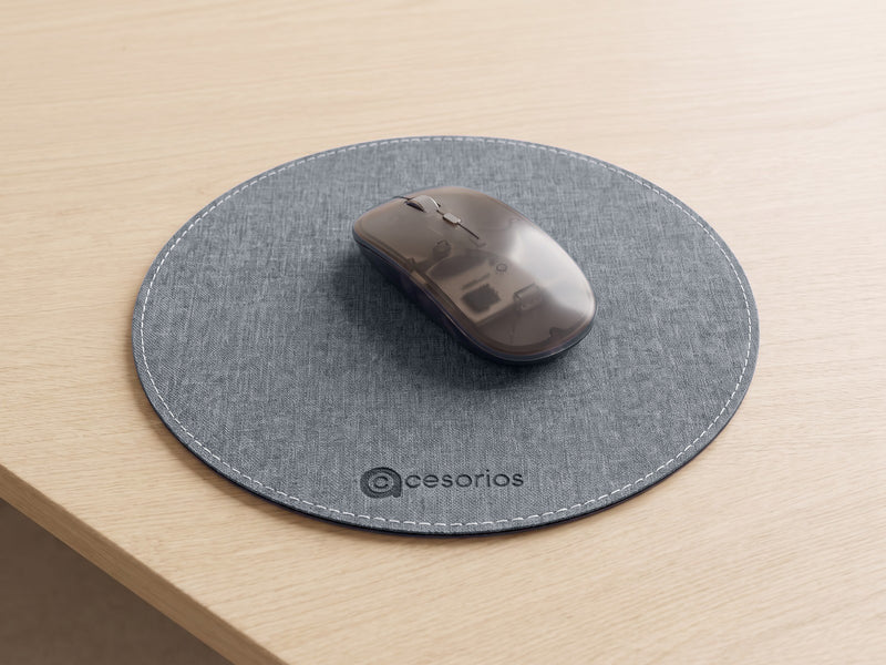 Flat round mouse pad with a white stitched edge, lying completely flat