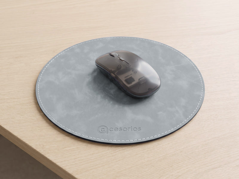 Flat round mouse pad with a white stitched edge, lying completely flat