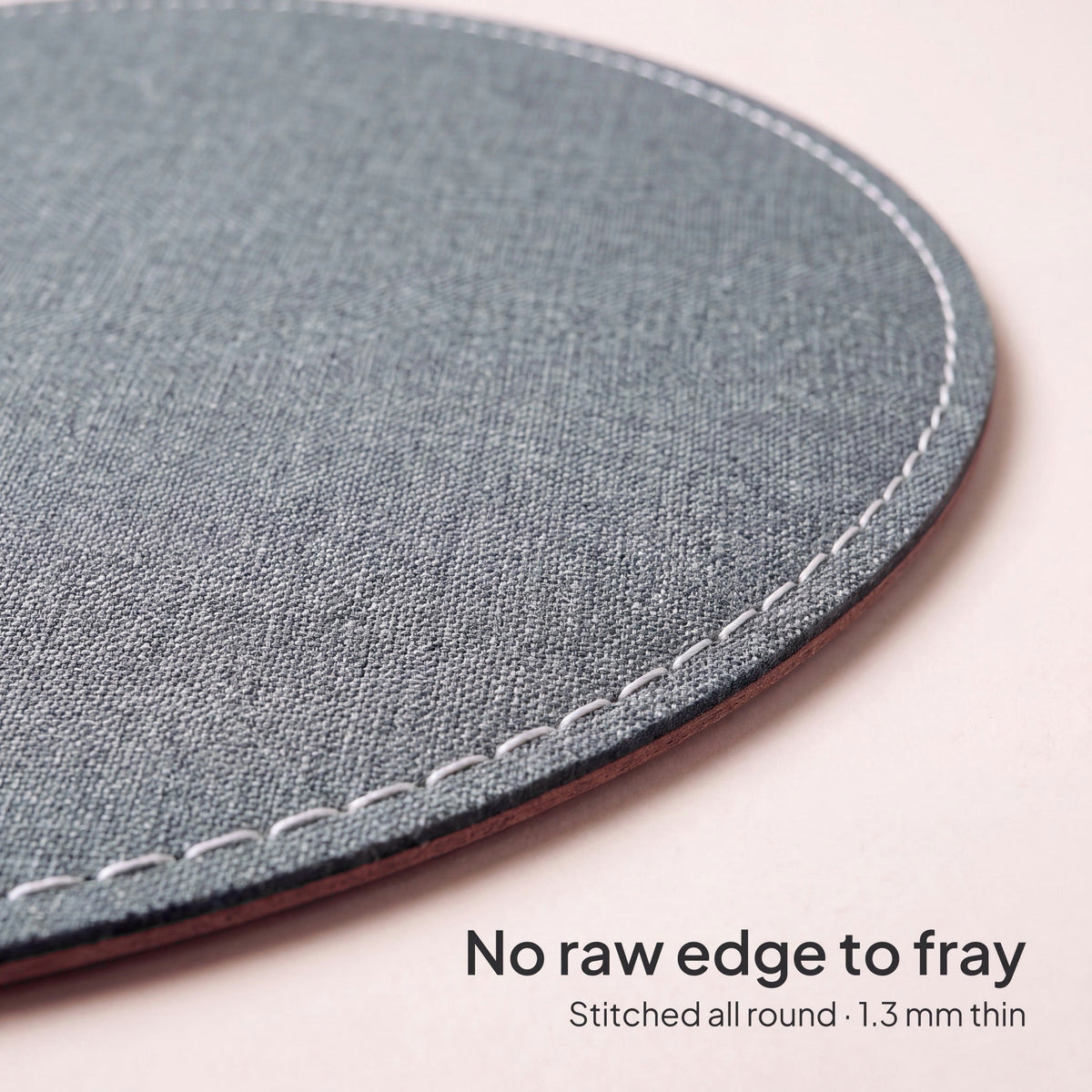 Ash Grey round chambray fabric mouse pad 23 cm - close-up of the white stitched edge, 1.3 mm thin
