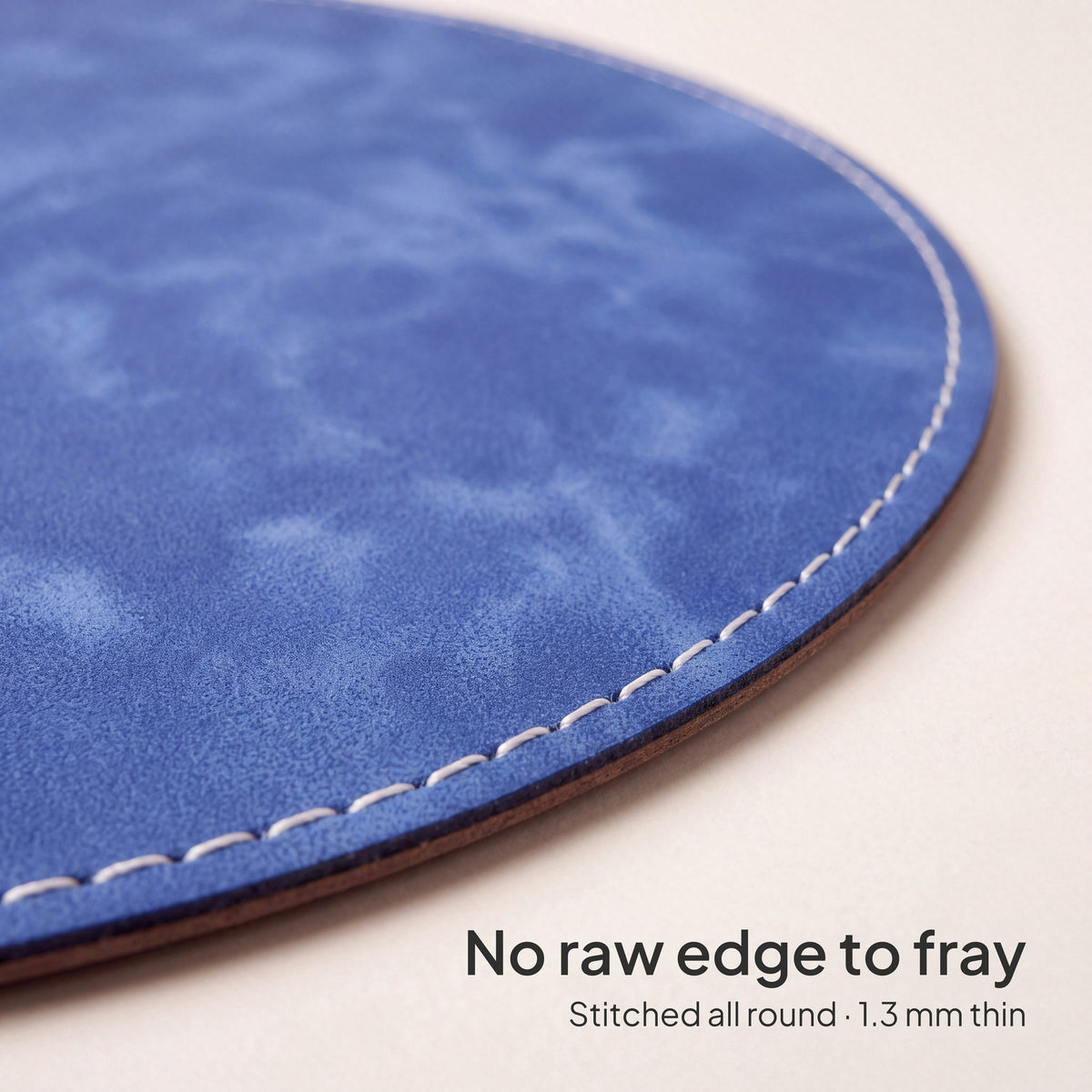 Royal Blue round vegan leather mouse pad 23 cm - close-up of the white stitched edge, 1.3 mm thin