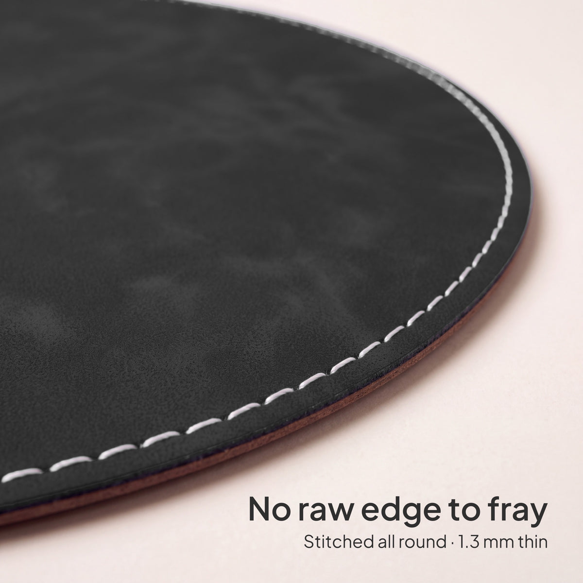 Slate Charcoal round vegan leather mouse pad 23 cm - close-up of the white stitched edge, 1.3 mm thin