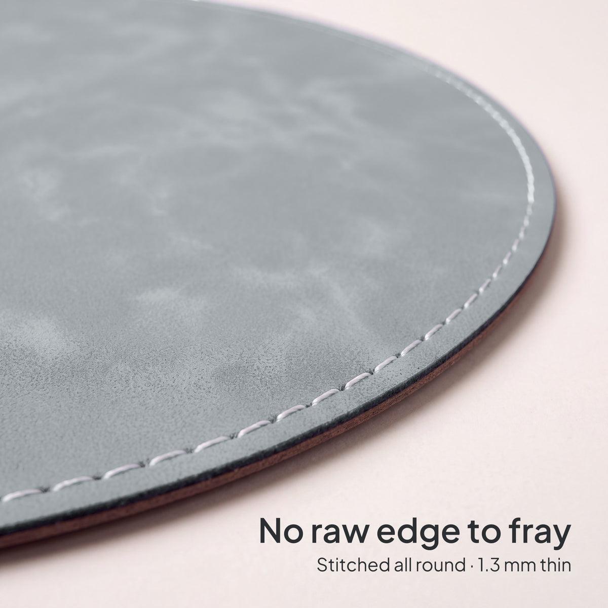 Stone Grey round vegan leather mouse pad 23 cm - close-up of the white stitched edge, 1.3 mm thin